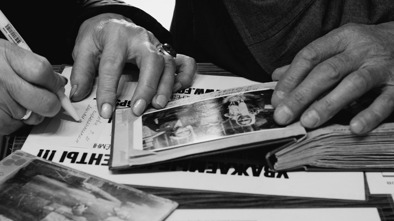 Hands turning the pages of an old photo album